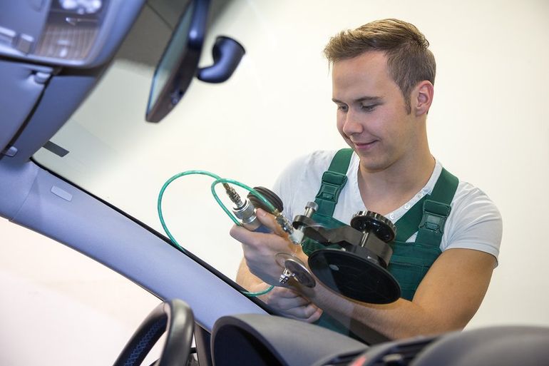 man doing auto glass repair