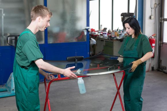 man and woman carrying the windshield