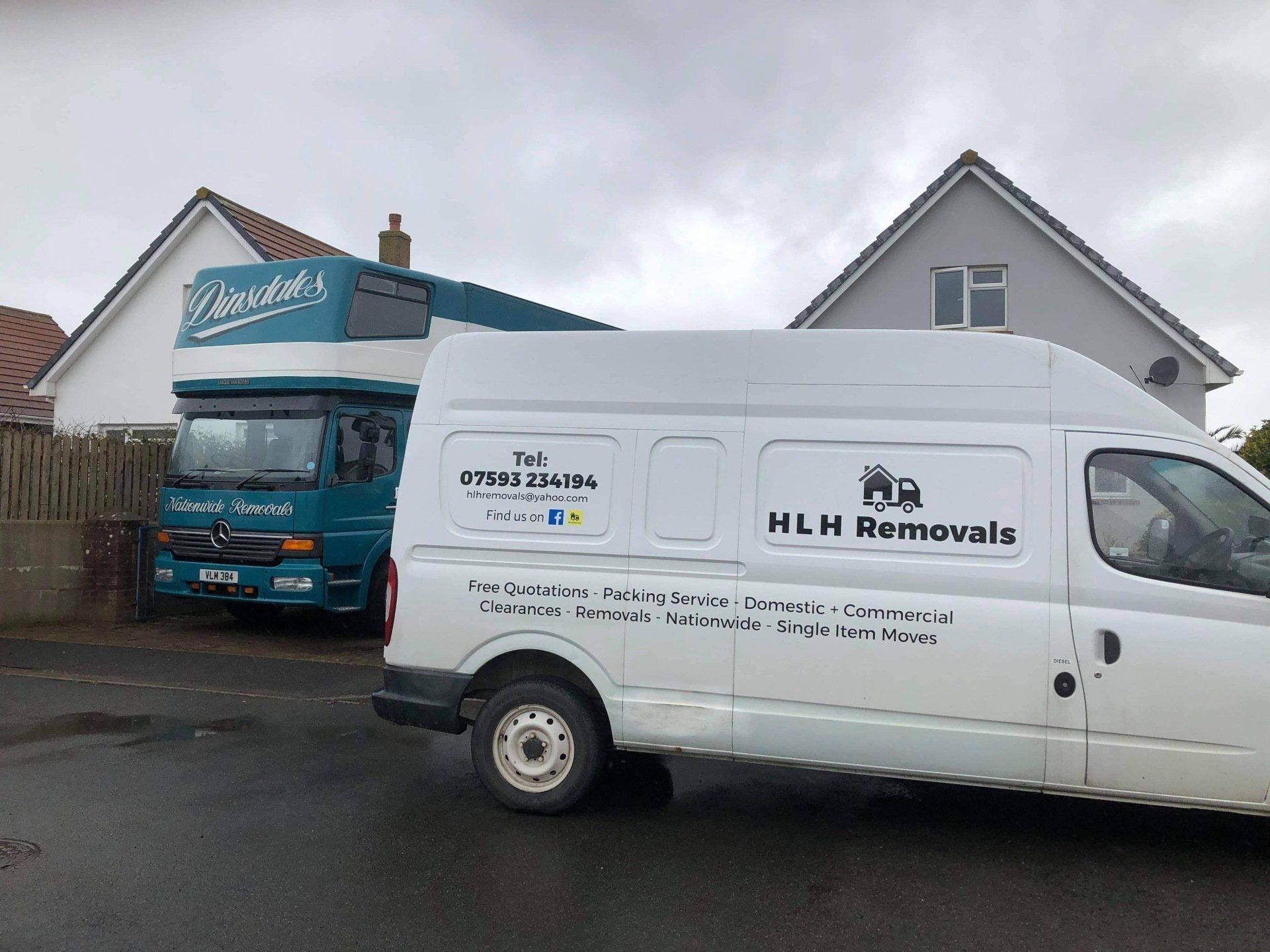 White HLN Removals van parked outside houses beside a teal truck in a residential street