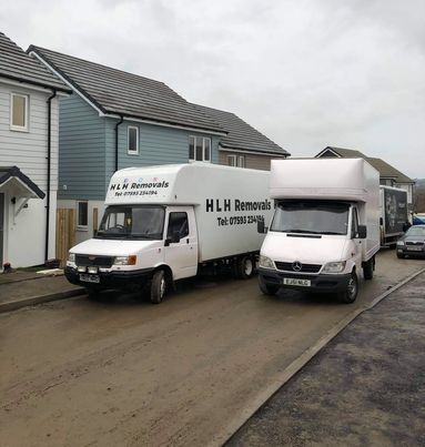 2 HLH Removal trucks on road