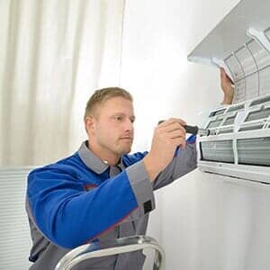 Man fixing AC — Ventilation in South Sioux City, NE Man fixing AC — Ventilation in South Sioux City, NE