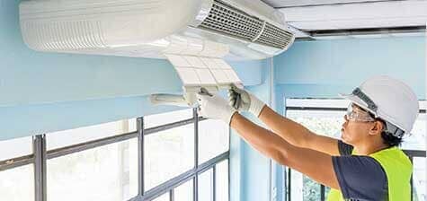 Technician Repairing Air Conditioner — Ventilation in South Sioux City, NE Technician Repairing Air Conditioner — Ventilation in South Sioux City, NE