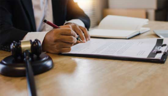 Lawyer Holding a Pen — Savannah, GA — J. Scott Vaughan Attorney at Law