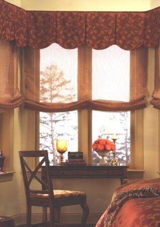 A bedroom with a bed a chair and a window
