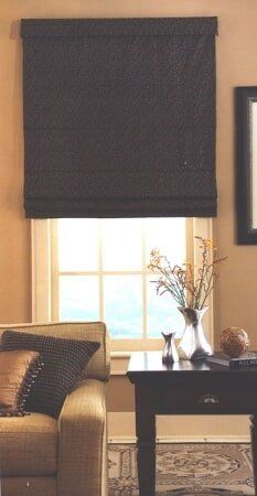 A living room with a couch a table and a window