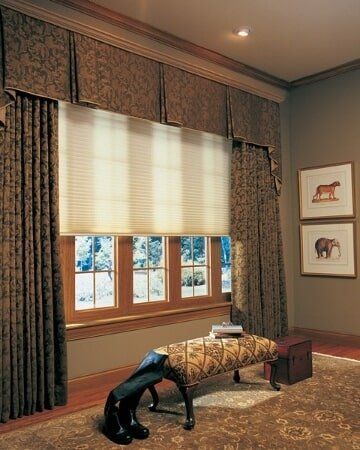 A living room with a bench in front of a window