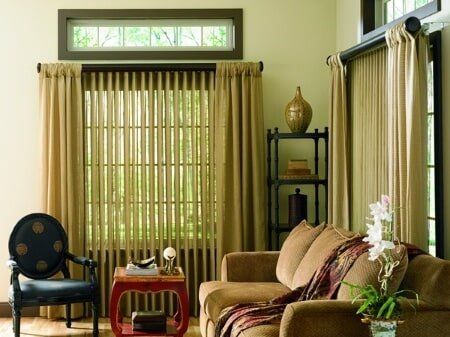 A living room with a couch a chair and a window