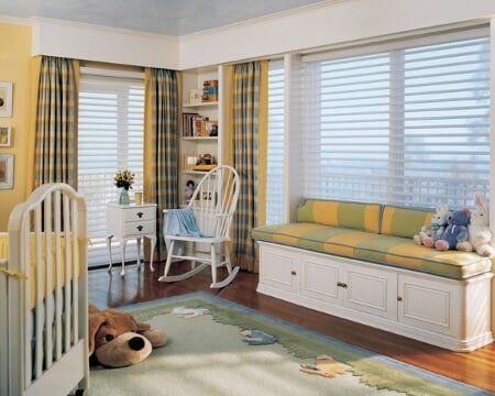 A baby 's room with a crib , rocking chair , and couch.