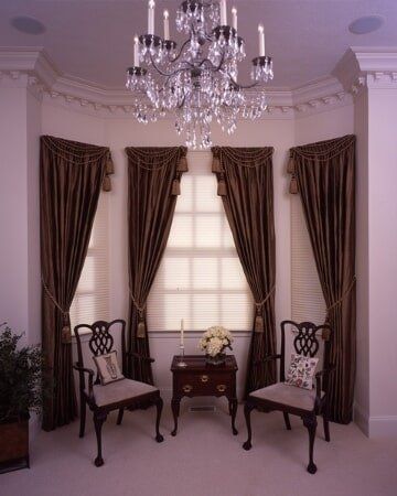 A living room with two chairs and a chandelier