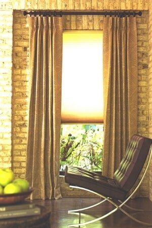 A living room with a chair and a window with curtains