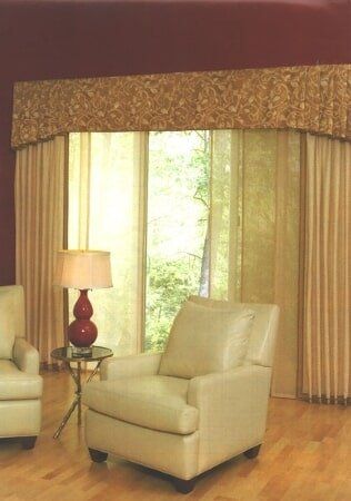 A living room with two chairs and a lamp
