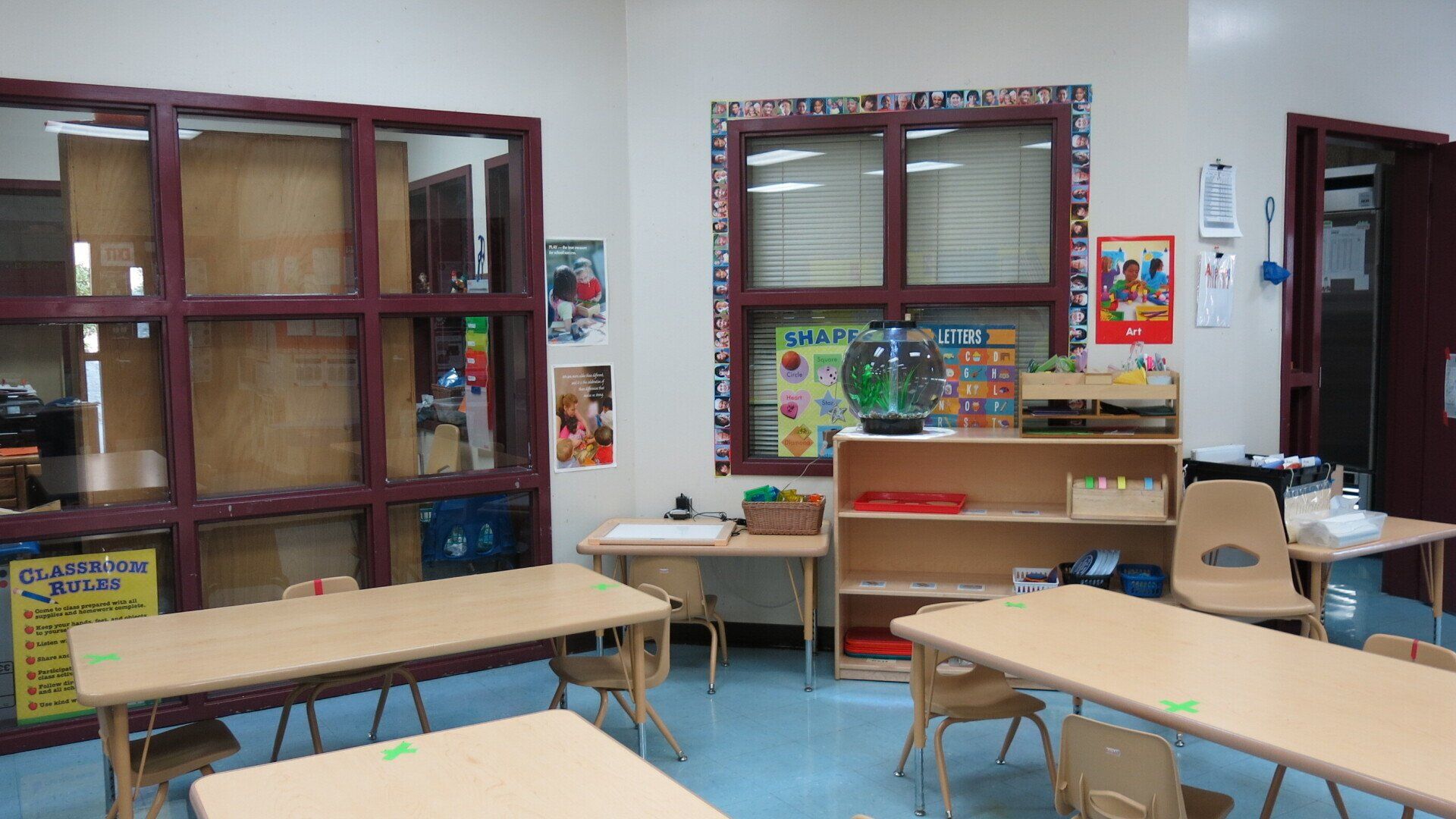 A classroom with tables and chairs and a sign that says christmas is coming