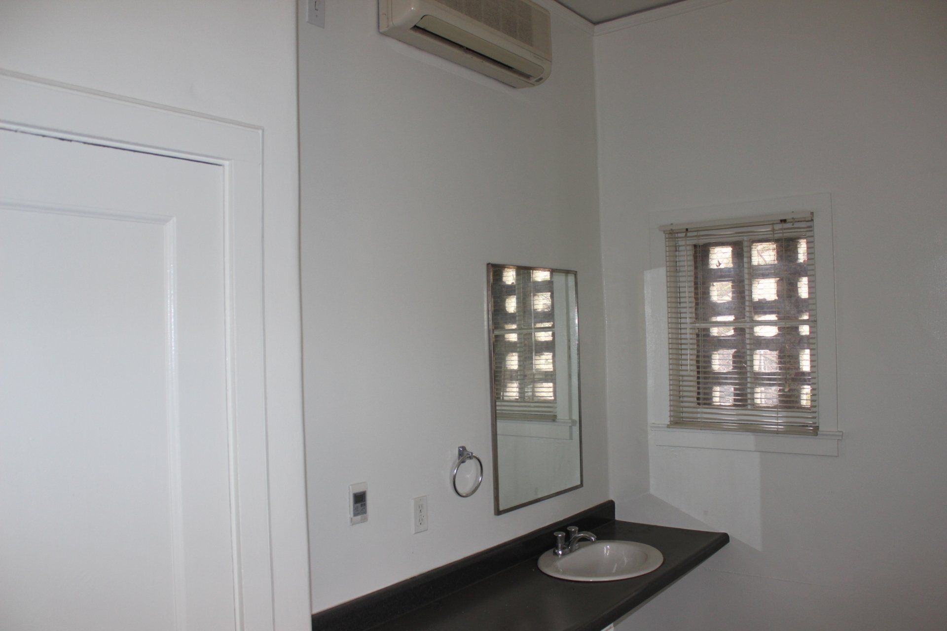 A bathroom with a sink and a mirror.