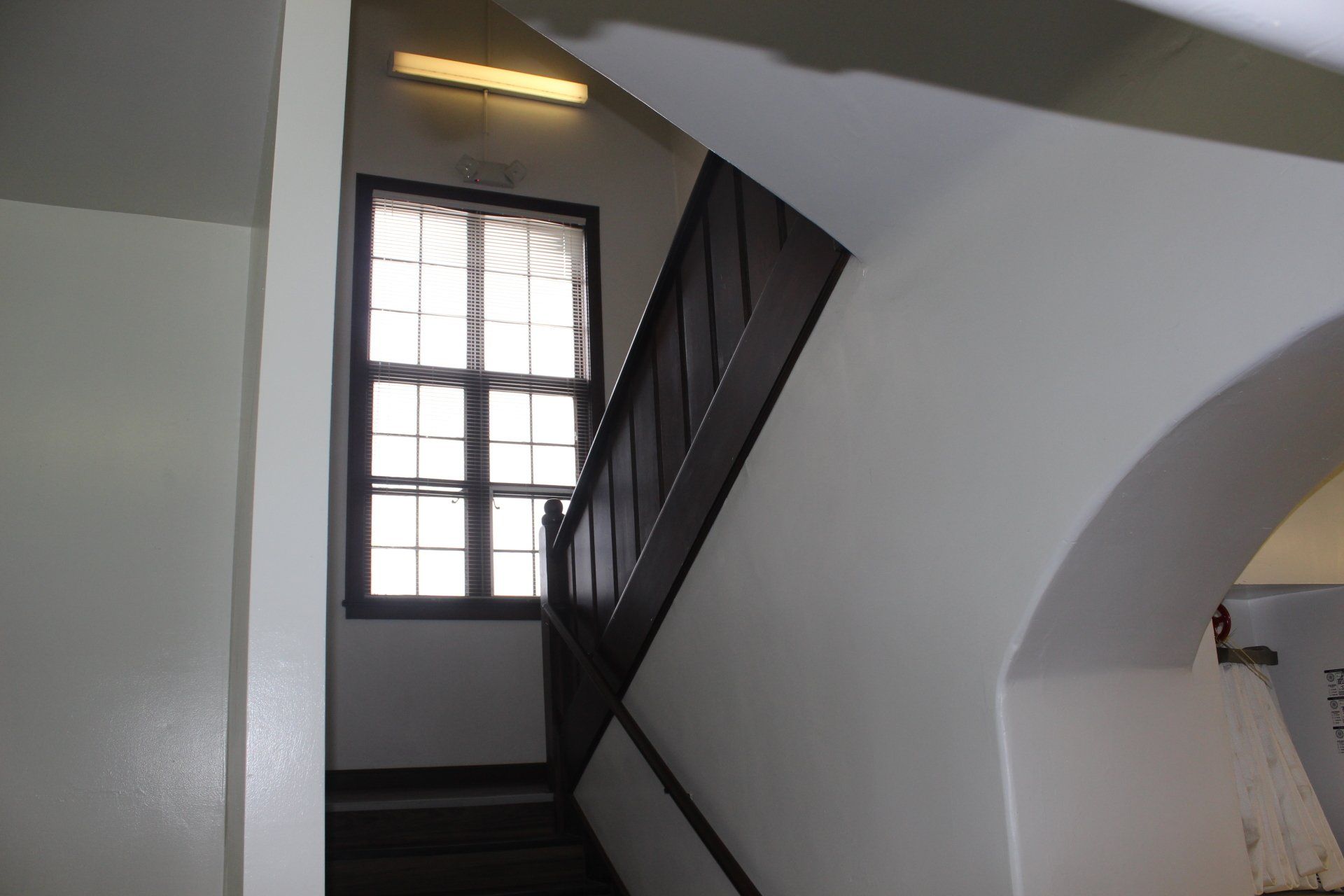 A staircase with a window on the side of it