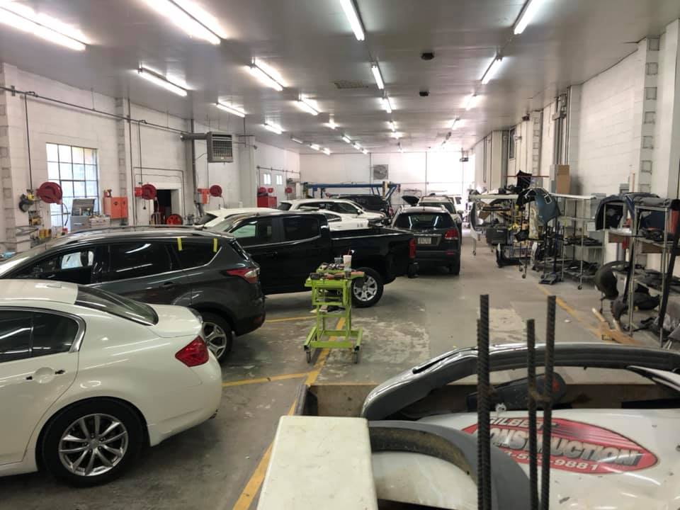 A lot of cars are parked in a garage.