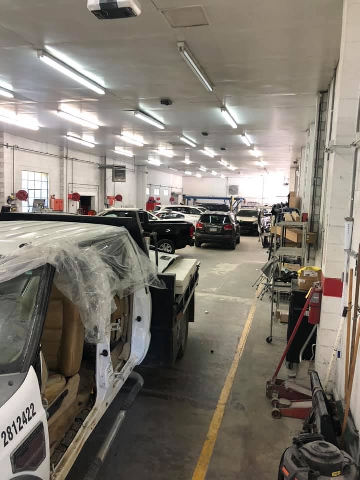 A large garage with a lot of cars in it.