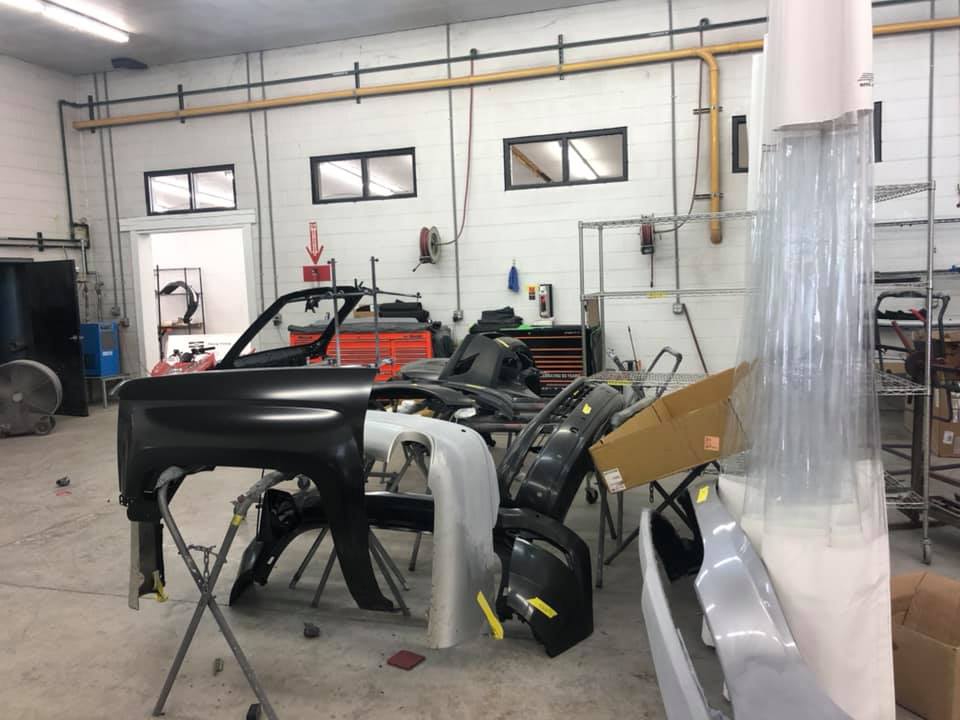 A car is being built in a garage.