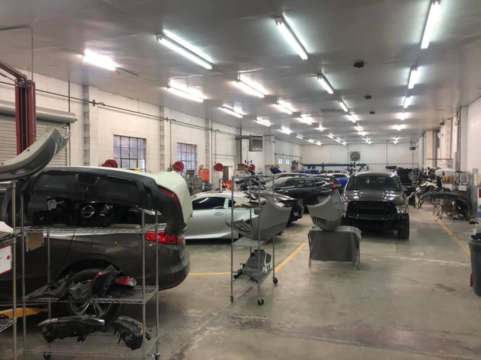 A large garage filled with cars being worked on.