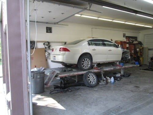 Damaged White Sedan — Dover, OH — Cua Refinishing Co.