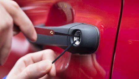 Cars — Human Hand Opening Car's Door With Lock Picker in Pine Bluff, AR Cars — Human Hand Opening Car's Door With Lock Picker in Pine Bluff, AR