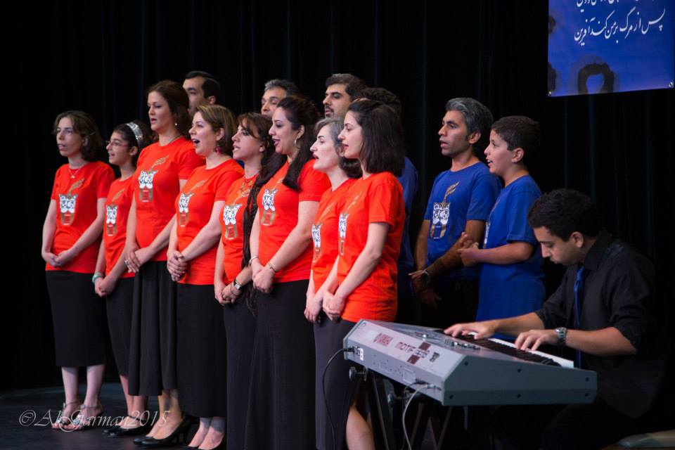 A man is playing a keyboard in front of a choir