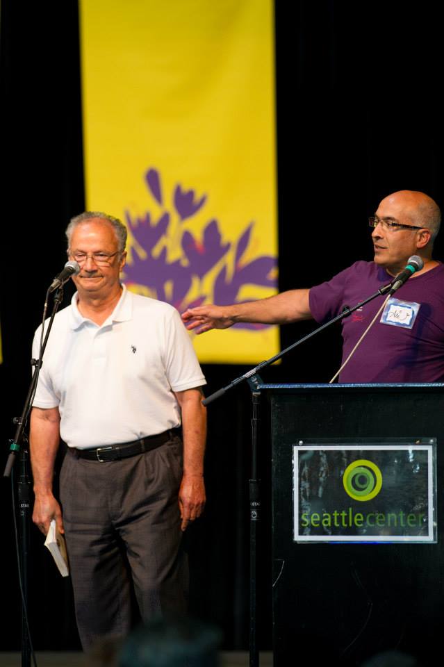 Two men are standing in front of a podium that says seattle central