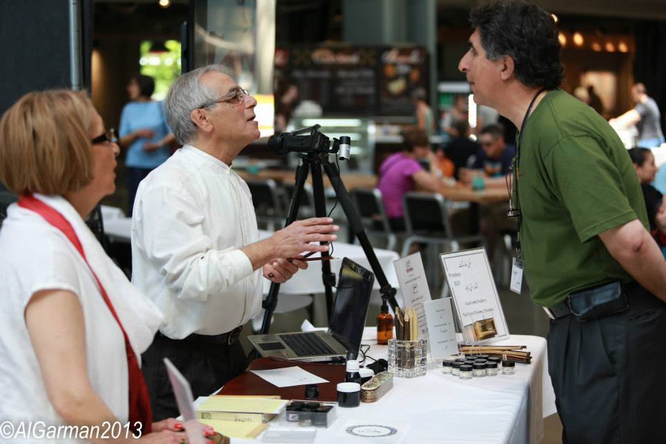 A man in a green shirt is talking to a woman and a man in a white shirt