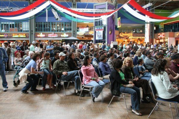 A large group of people are sitting in a large room