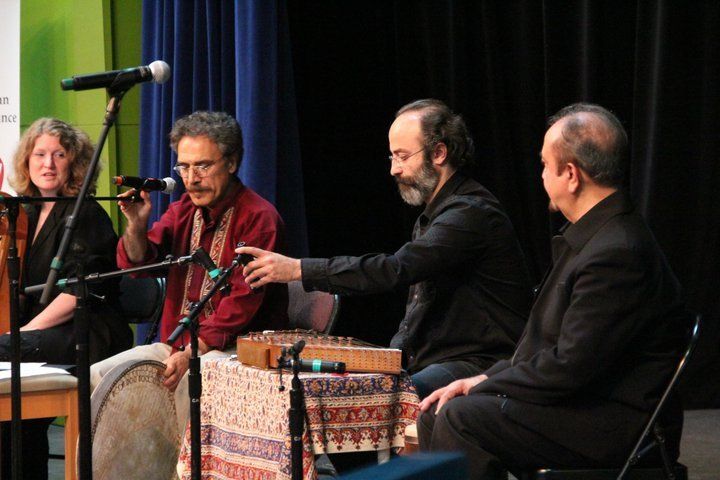 A group of people are playing musical instruments on a stage.