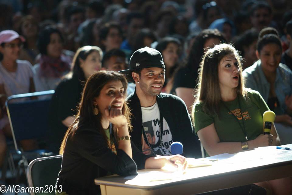 A group of people sitting at a table with the year 2013 on the bottom