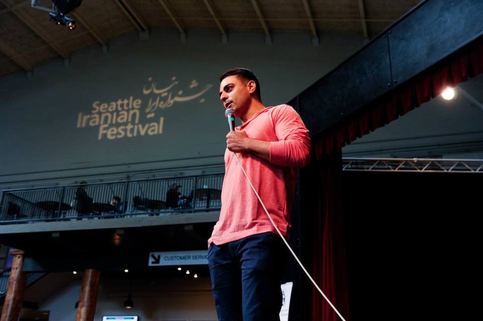 A man stands in front of a microphone at the seattle irapian festival