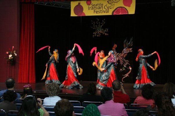 A group of people are watching a performance at a festival