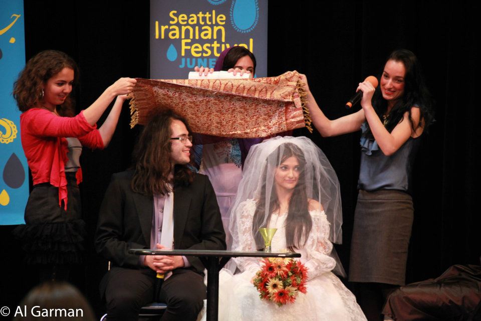 A group of people are standing around a woman in a wedding dress