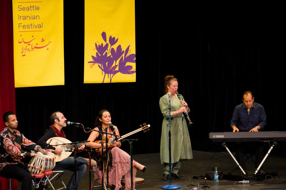 A group of people are playing musical instruments on a stage.