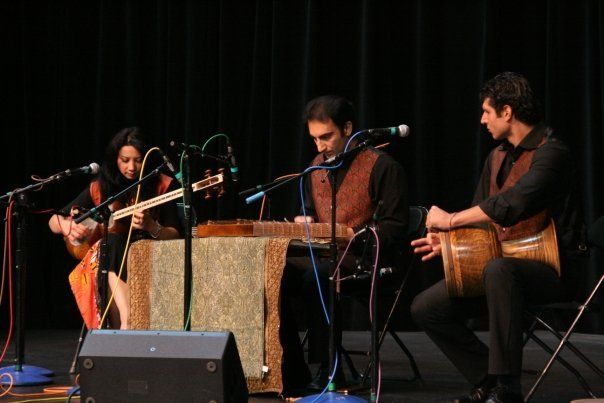 A group of people are playing musical instruments on a stage.