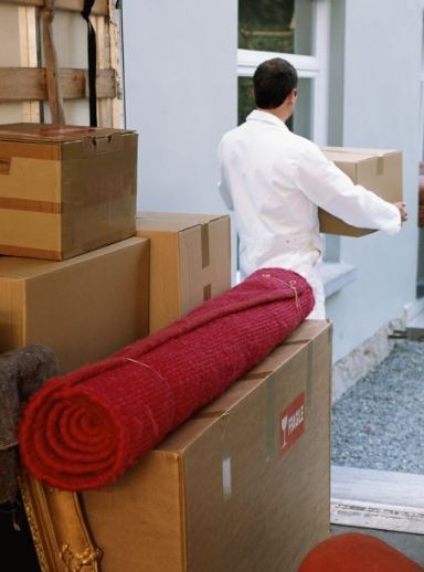 Removals man unloading packing boxes