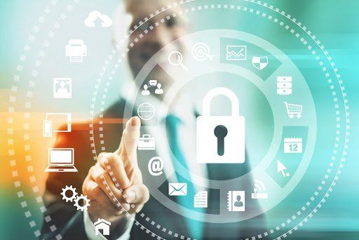 A man in a suit is pointing at a padlock on a screen surrounded by icons.