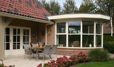 seating in a patio that is next to a conservatory
