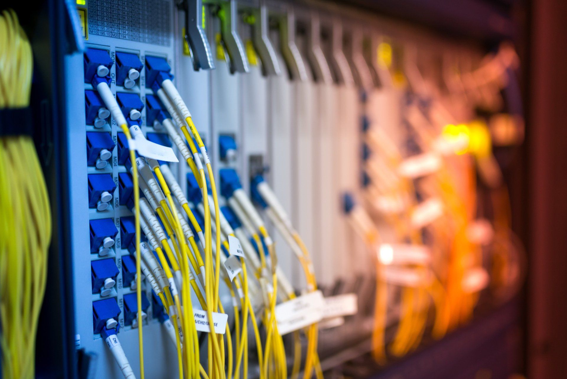 A bunch of wires are connected to a server in a data center.