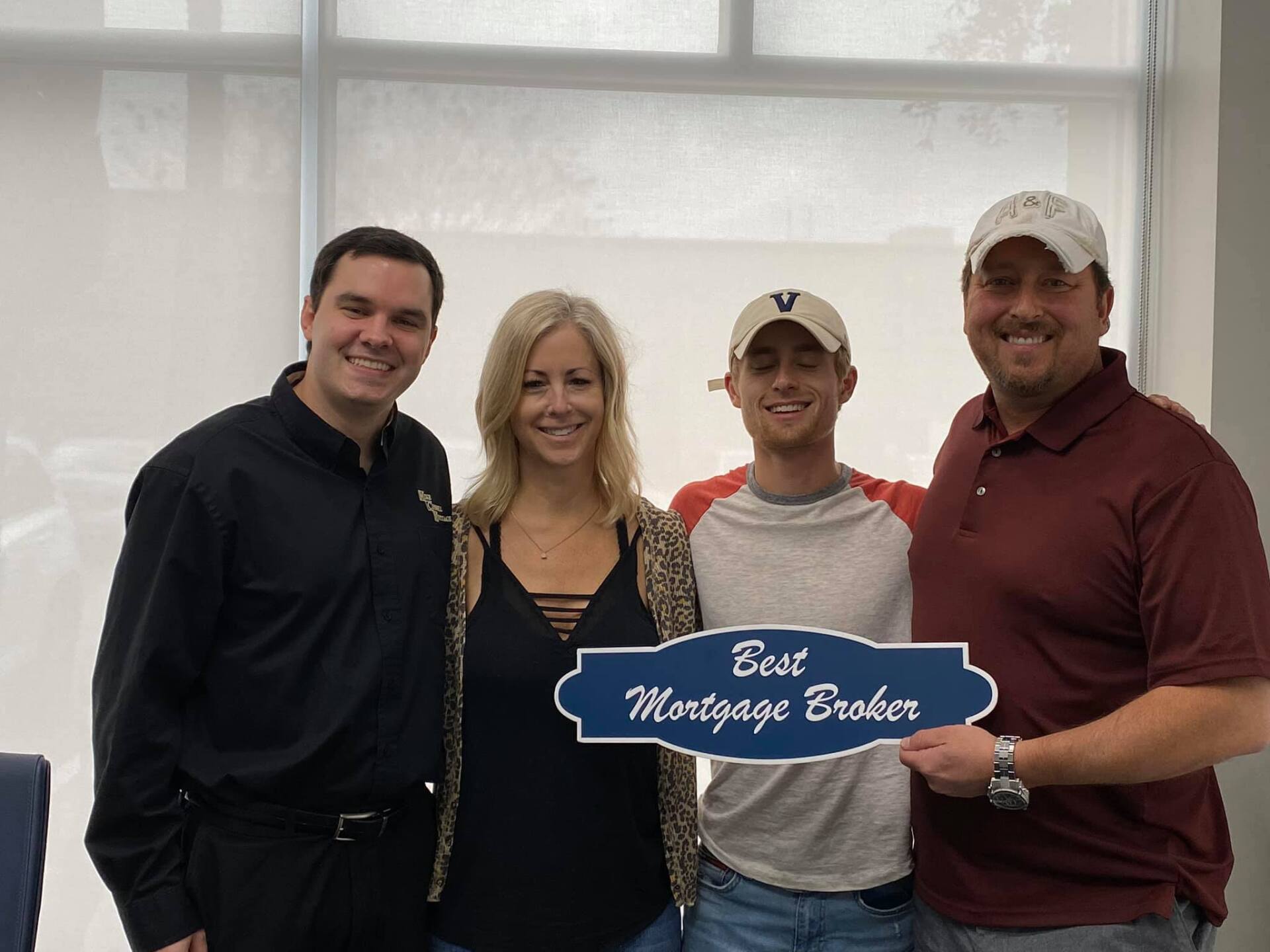 Four people holding a 