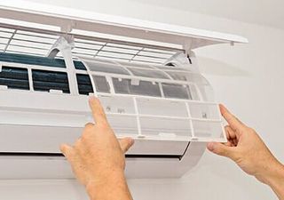 Air Conditioning Repair — Air Conditioner On A White Wall in Huntley, IL Air Conditioning Repair — Air Conditioner On A White Wall in Huntley, IL