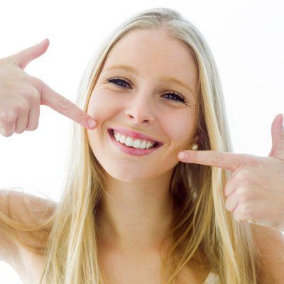 Dentures — Girl Pointing Teeth in Modesto, CA Dentures — Girl Pointing Teeth in Modesto, CA