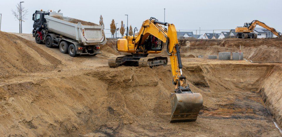 excavator clearing the site