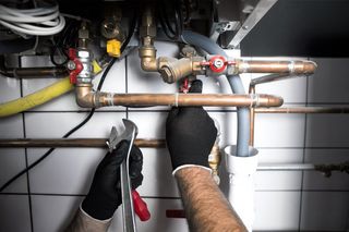 Plumbing — Hands of Plumber with a Wrench in Amarillo, TX