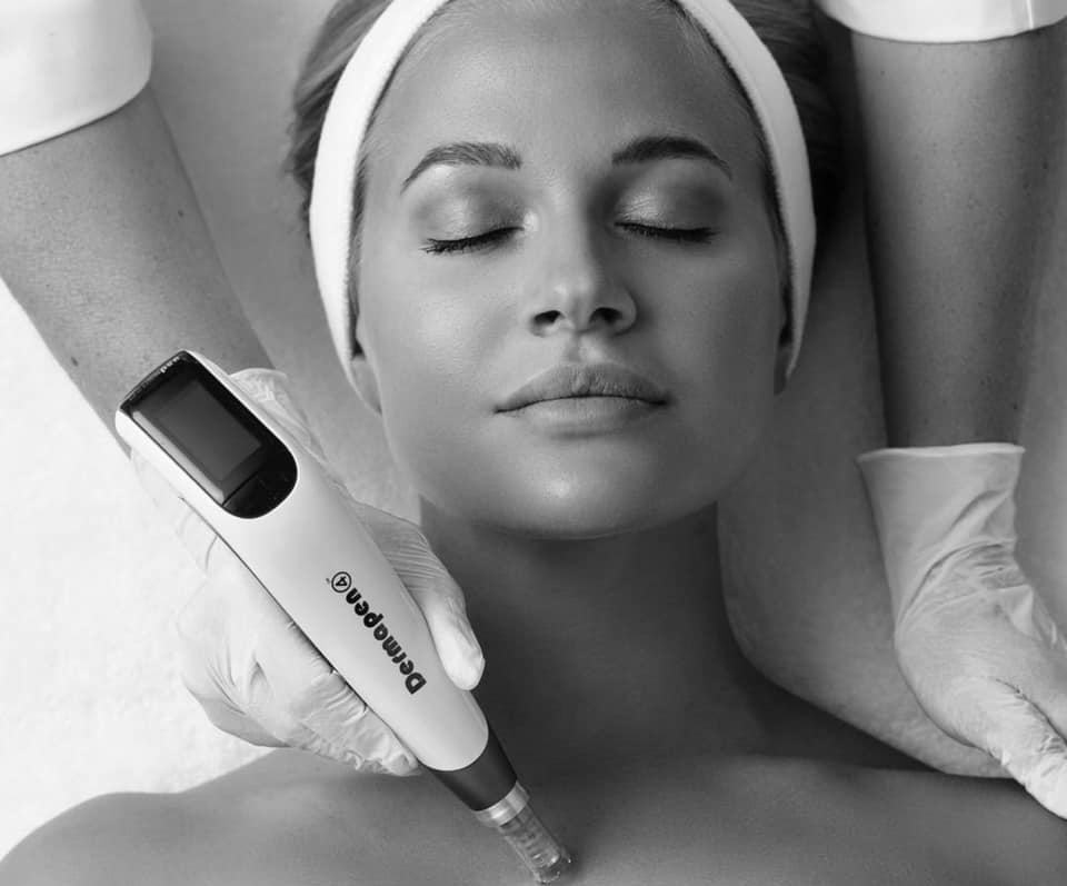 A woman is getting a treatment on her face with a machine.
