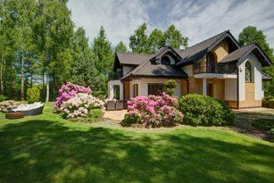 Detached House with Beauty Garden — Landscaping Services in Janesville, WI Detached House with Beauty Garden — Landscaping Services in Janesville, WI