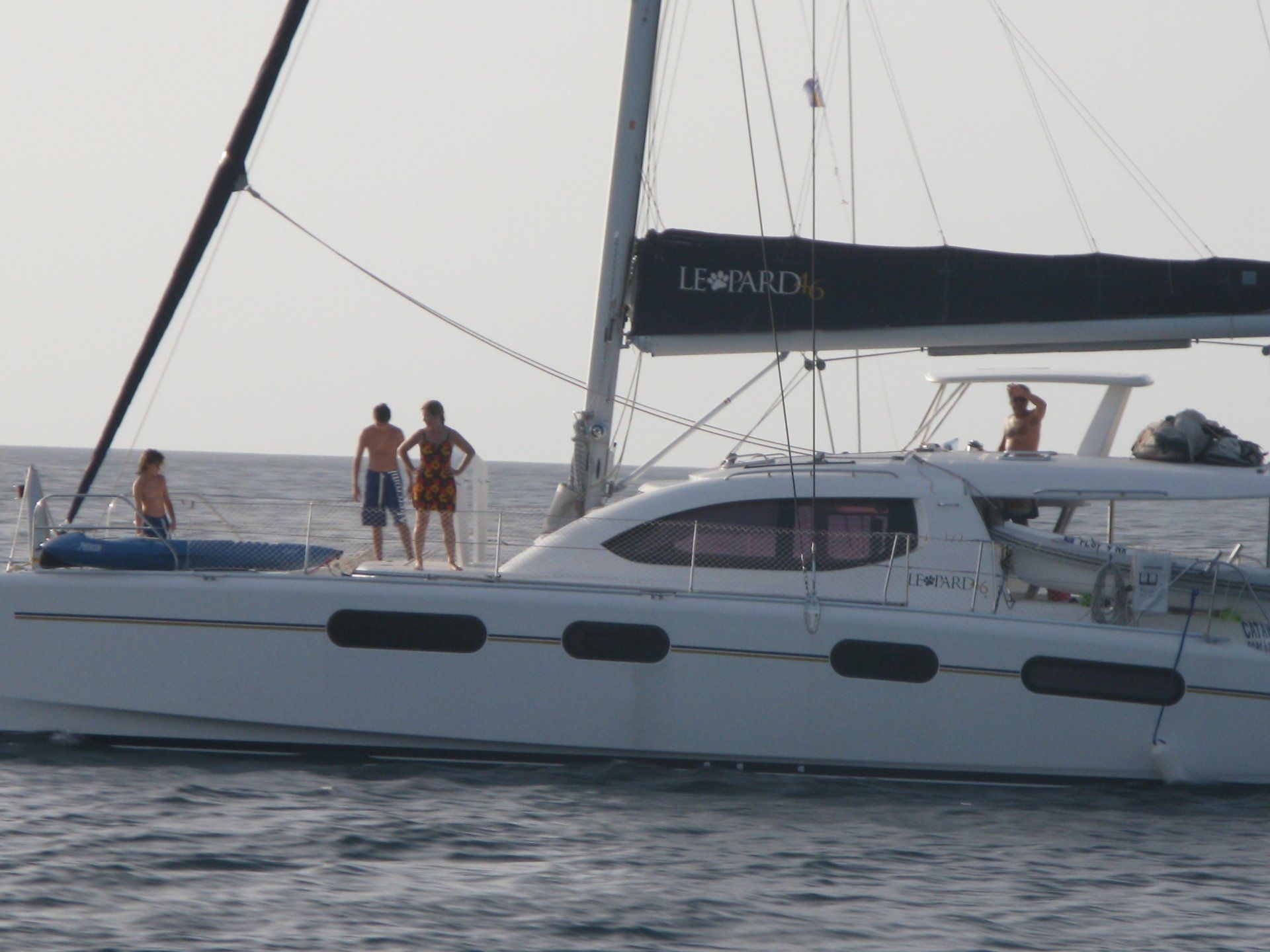 A sailboat with a black sail that says lemonfish on it