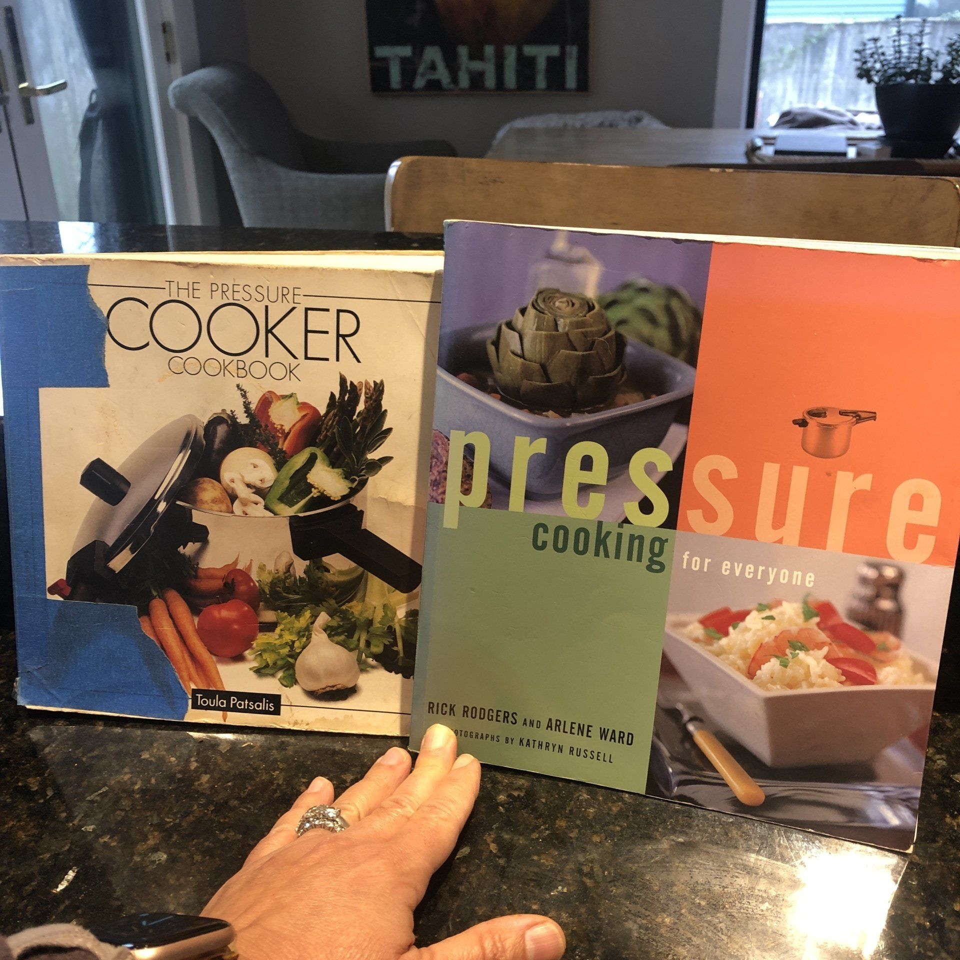 A person is holding a book about pressure cooking