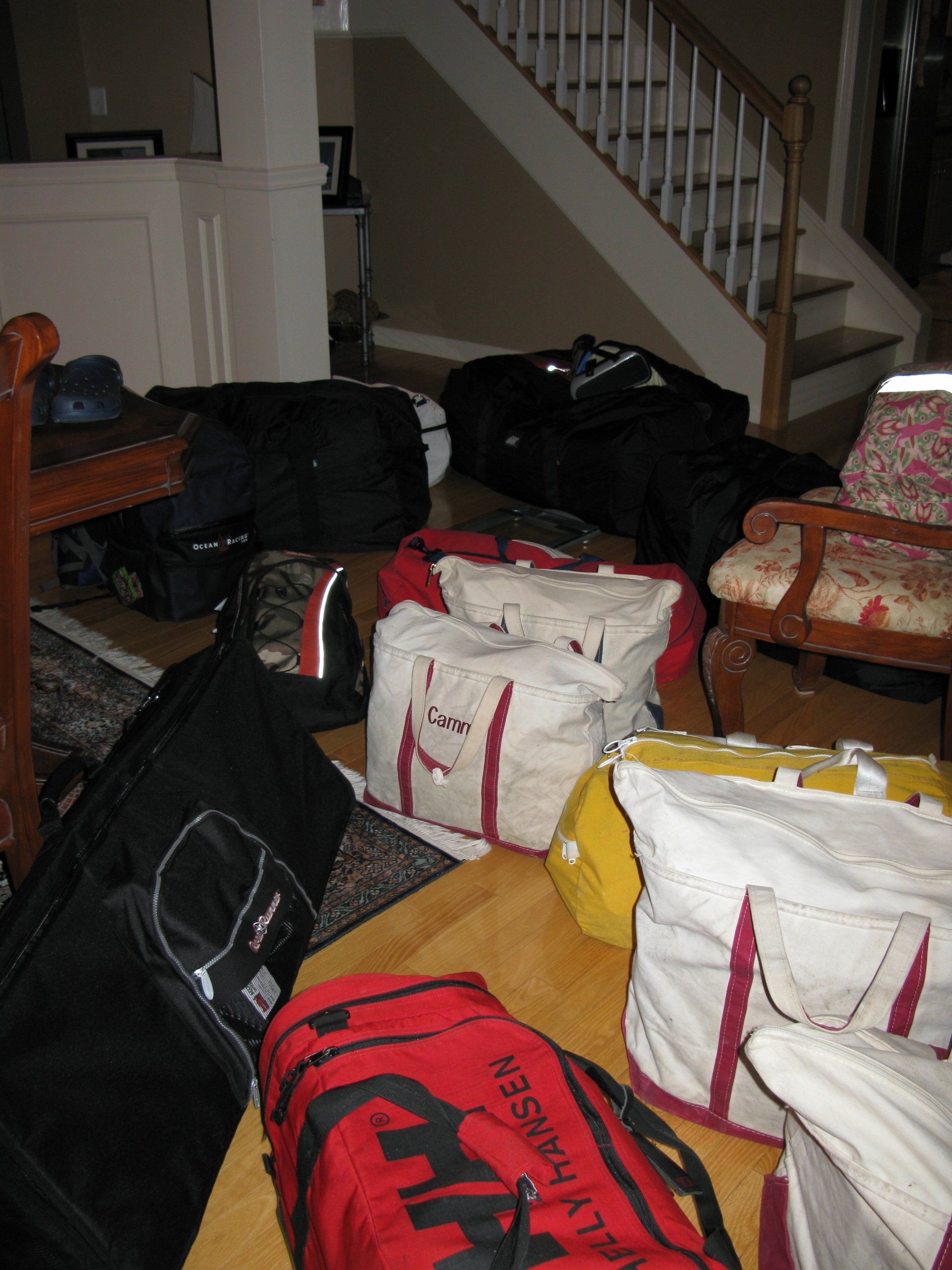 A bunch of bags on the floor one of which has the word ambulance on it