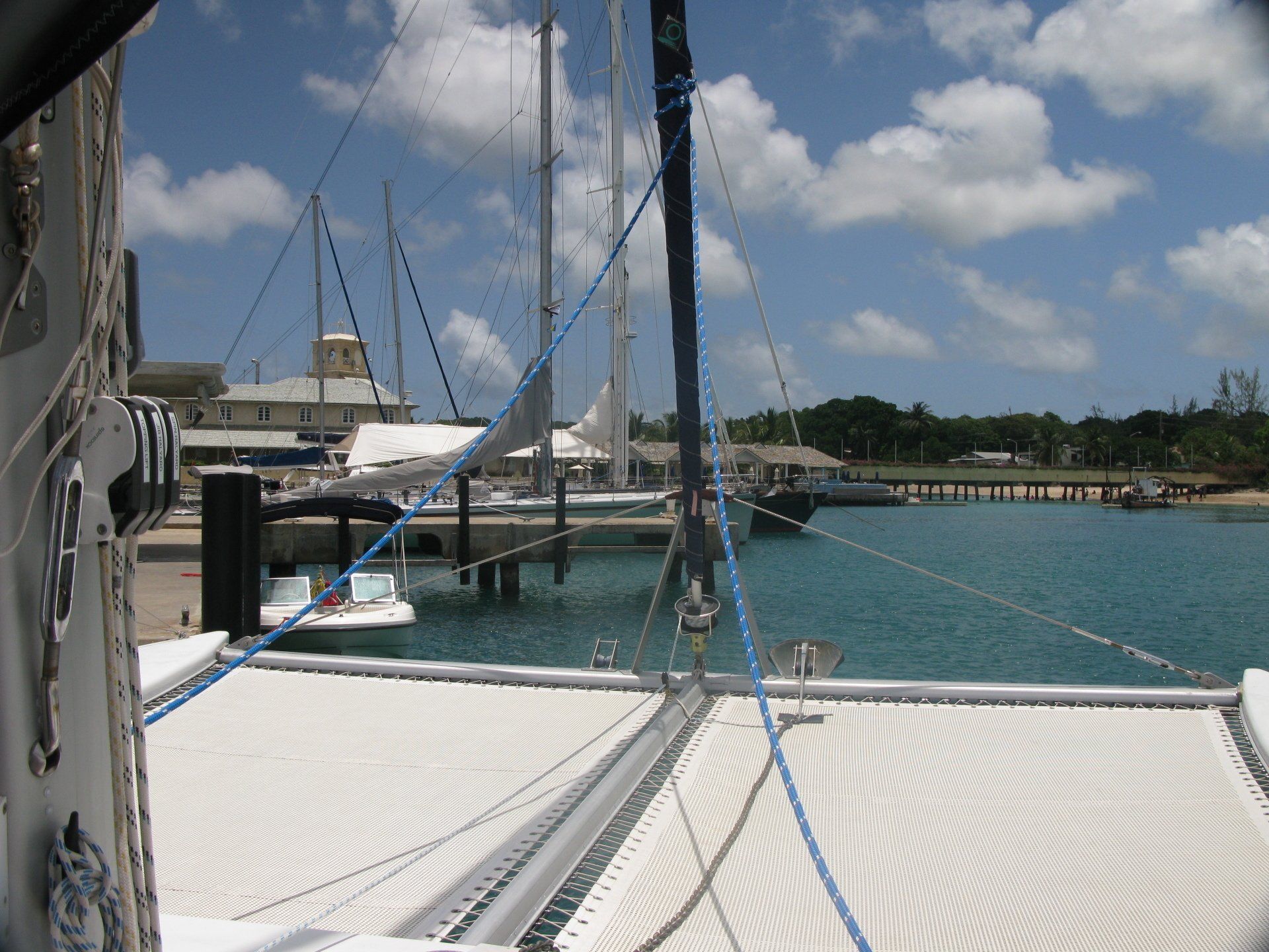 A sailboat is docked at a marina with boats in the water
